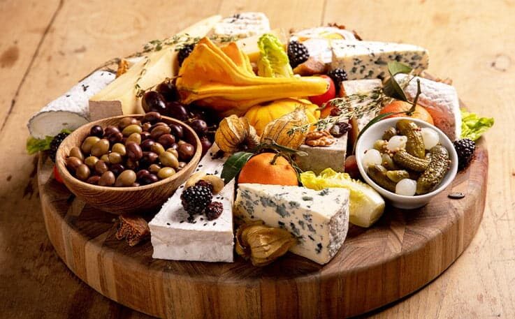 Wooden board of cheeses to share